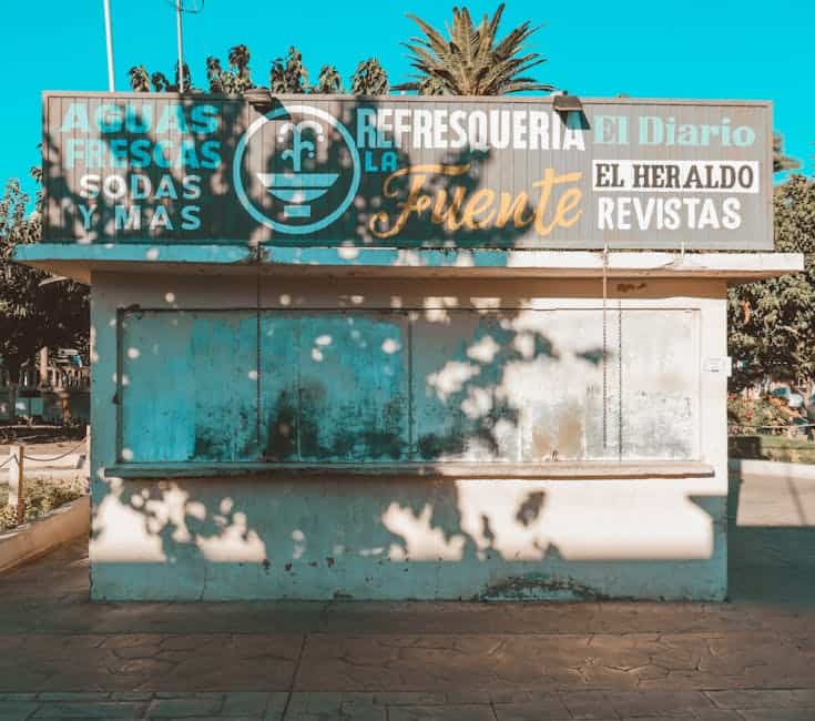 A closed refreshment stand with colorful signage in Pedro Meoqui, Chihuahua, Mexico.