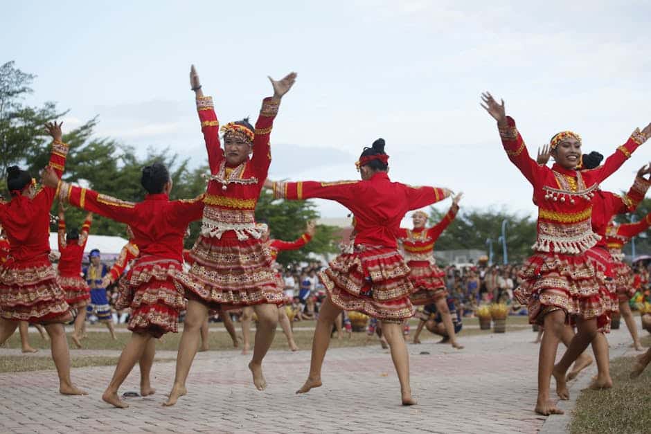 Energetic performance of traditional dance by women in festive attire at a cultural festival in Mati, Philippines.
