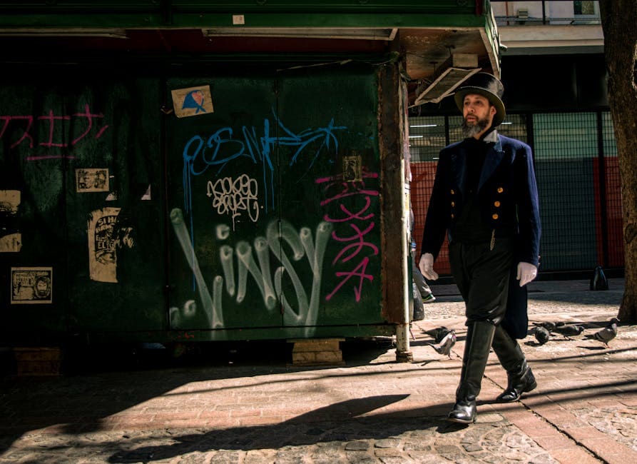 A man dressed in steampunk fashion walks past graffiti walls in Buenos Aires, Argentina.