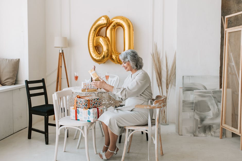 Senior woman celebrates her 60th birthday indoors with gifts and decor.
