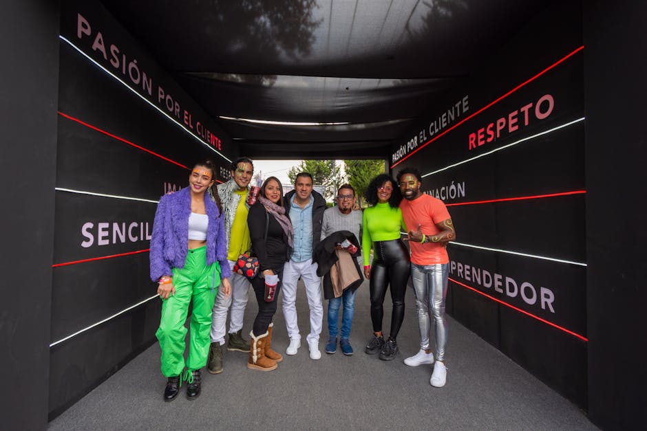 Group of joyful adults enjoying a festive event in Mexico City, showcasing diversity and bright fashion.