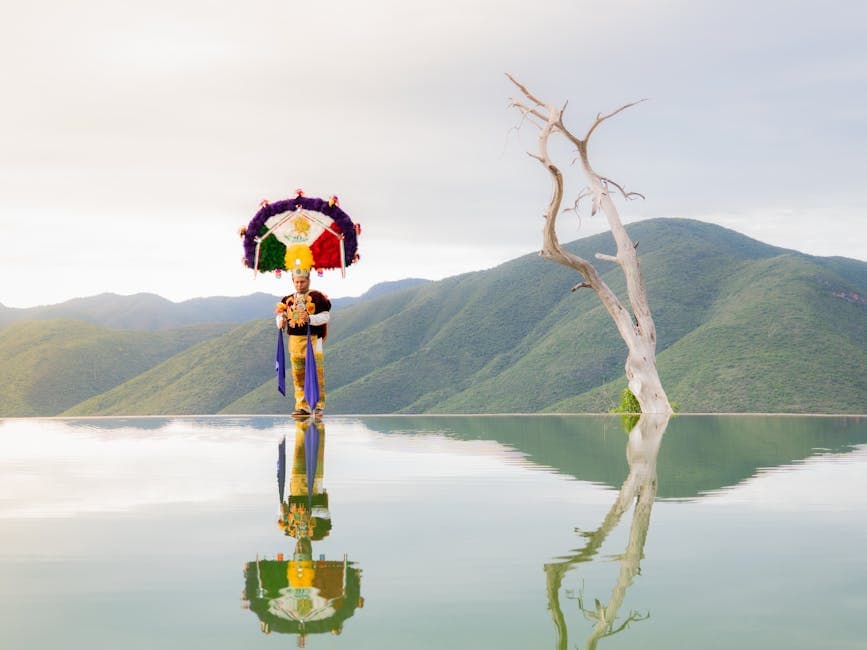 Traditional dancer reflects at Hierve el Agua in Oaxaca, capturing cultural essence and natural beauty.