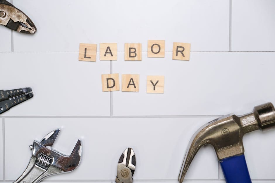Labor Day themed image with tools and Scrabble tiles spelling 'Labor Day'.